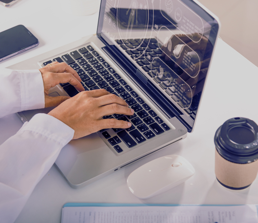 a photo of a physician checking his computer