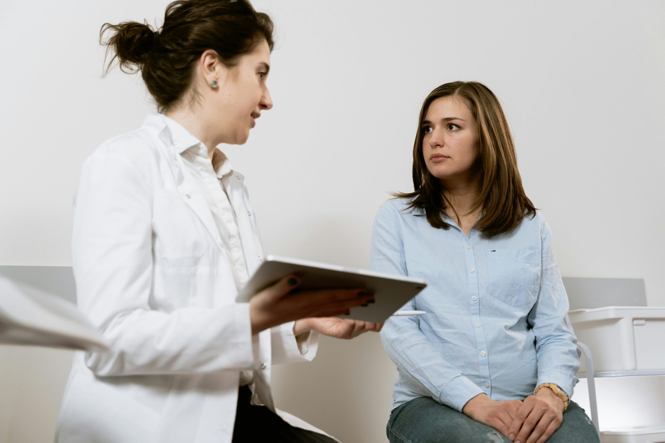 a surgeon consulting a patient on their options