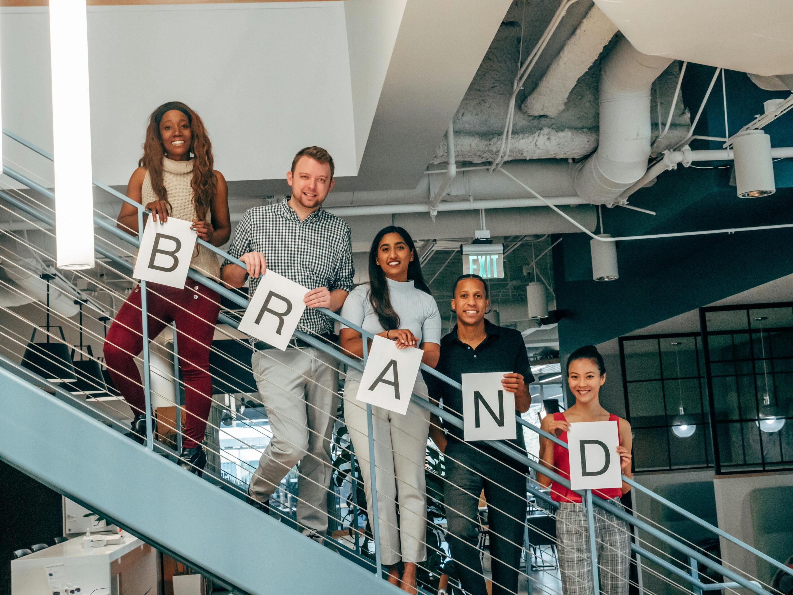 Startup holding branding signs on stairs